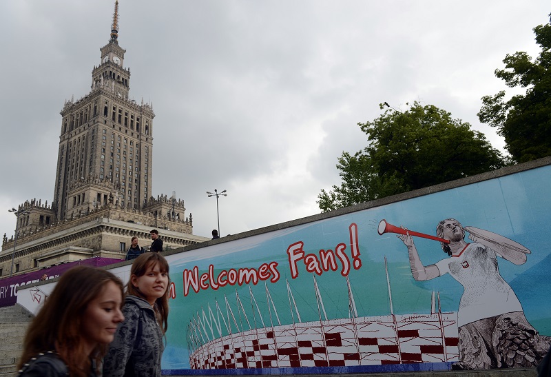 Two women walk by the Euro 2012 football fanzone near the Palace of Culture in the centre of Polandu00e2u20acu2122s capital Warsaw. u00c2u00acu00e2u20acu201d AFP pic