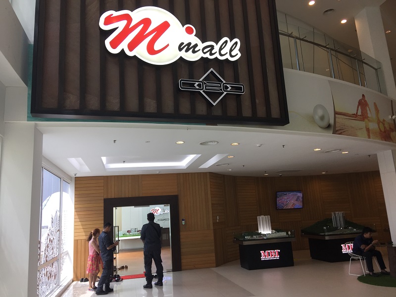 Two government officials stand guard outside the office while the raid is ongoing inside. u00e2u20acu201d Picture by Opalyn Mok 