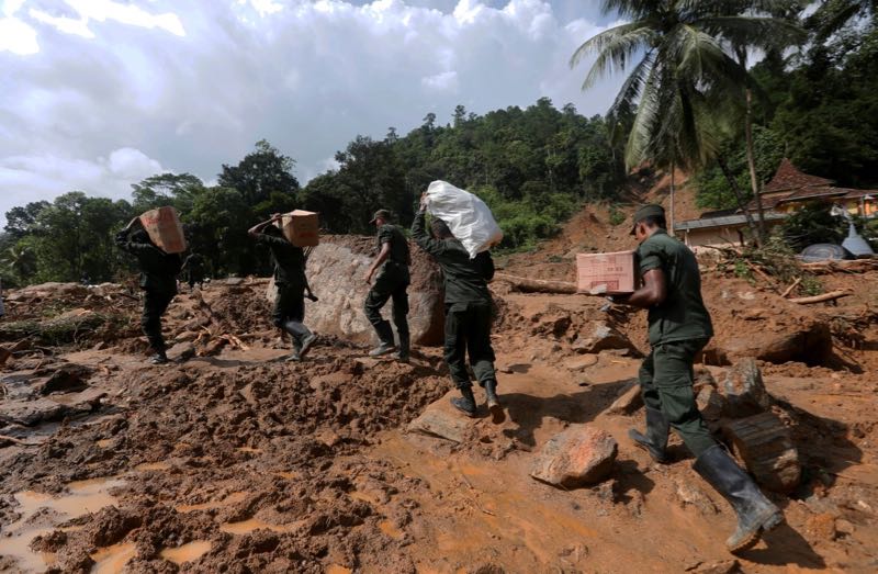 Sri Lankan army soldiers carry food and water for landslide affected people, through the site, during a rescue mission in Athwelthota village, in Kalutara, Sri Lanka May 28, 2017. u00e2u20acu201d Reuters pic
