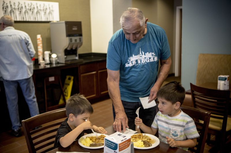 Guests Henry Acevedo and his twin grandsons Evan and Liam Brought eat breakfast at the Sleep Inn/MainStay Suites in Meridian, Mississippi. 