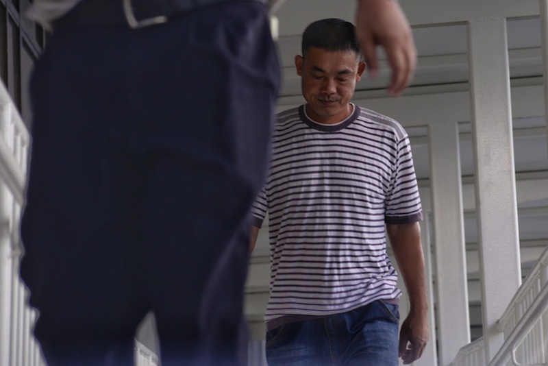 Wang Jianpo who left a luggage unattended at Hougang MRT station and sparked a security scare, has pleaded guilty to one count of causing public nuisance. u00e2u20acu201d PIcture by Robin Choo/TODAY