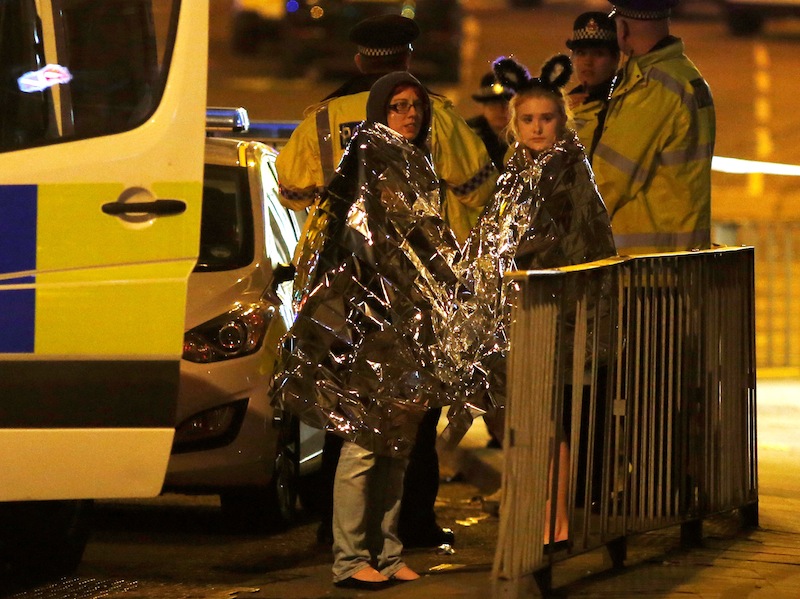 Two women wrapped in thermal blankets stand near the Manchester Arena, where US singer Ariana Grande had been performing, in Manchester, May 23, 2017. u00e2u20acu201d Reuters pic