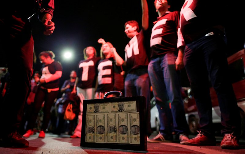 A suitcase containing fake money with images of Brazil's President Michel Temer and former speaker of Brazil's Lower House of Congress Eduardo Cunha is seen during a protest in Brasilia May 18, 2017. u00e2u20acu201d Reuters pic n