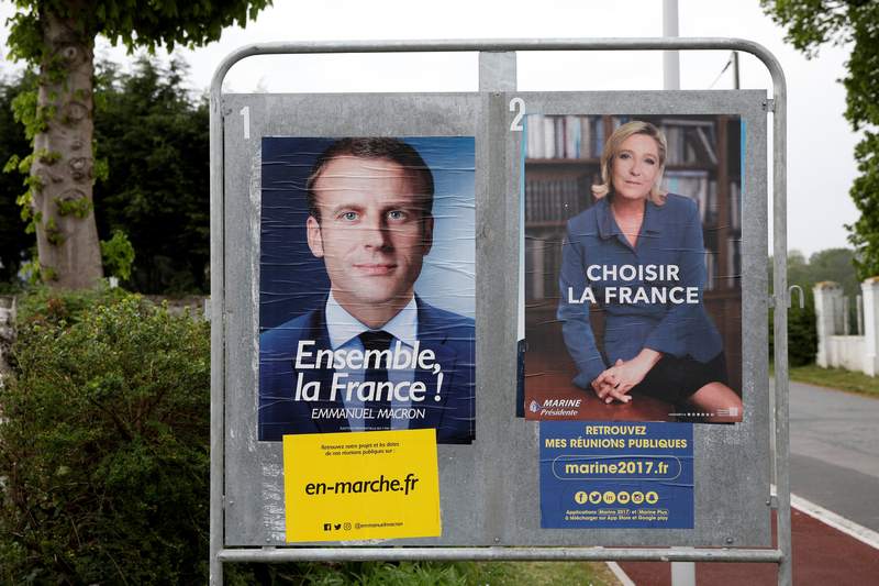 Emmanuel Macron (left)and Marine Le Pen are displayed in an election poster in Saint-Josse, northern France May 5, 2017. u00e2u20acu201d Reuters pic