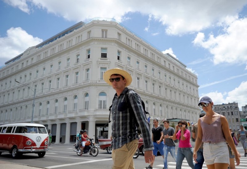 Tourists walk near the Manzana Kempinski Hotel, Cubau00e2u20acu2122s first luxury five-star, in Havana May 22, 2017. u00e2u20acu201d AFP pic