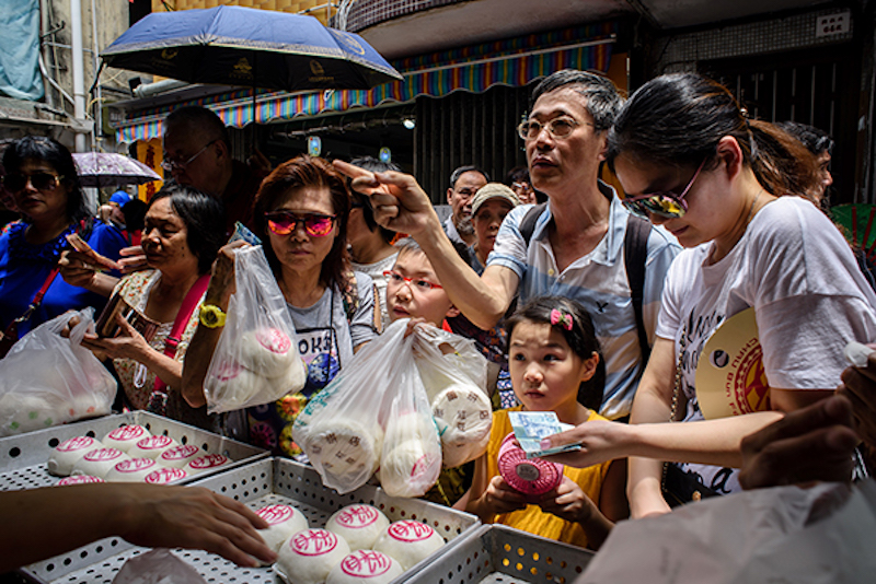 Customers buy traditional buns made for the annual Cheung Chau bun festival in Hong Kong May 3, 2017. — AFP pic