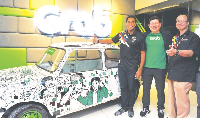 Khairy Jamaluddin (left) during the announcement of the sponsorship deal between Grab and the organisers of the KL SEA Games on May 23. u00e2u20acu2022 Bernama pic
