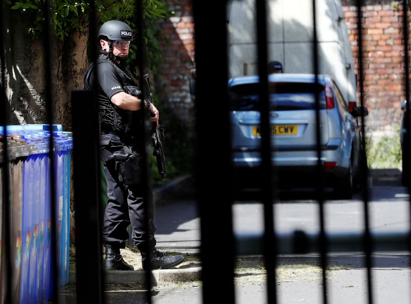 An armed police officer stands outside a residential property near to where a man was arrested in the Chorlton area of Manchester May 23, 2017. u00e2u20acu201d Reuters pic