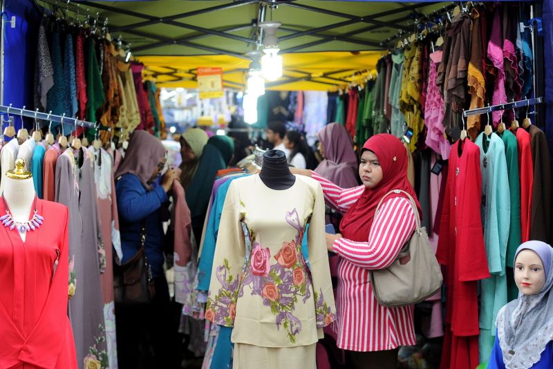 A woman shops for new clothes at a shop in Jalan Tuanku Abdul Rahman in Kuala Lumpur ahead of the Hari Raya Aidilfitri celebrations next month, May 31, 2017. u00e2u20acu2022 Bernama pic