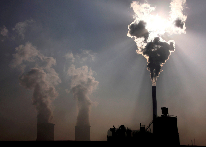 A coal-burning power plant can be seen behind a factory in the city of Baotou, in Chinau00e2u20acu2122s Inner Mongolia Autonomous Region October 31, 2010. u00e2u20acu201d Reuters pic