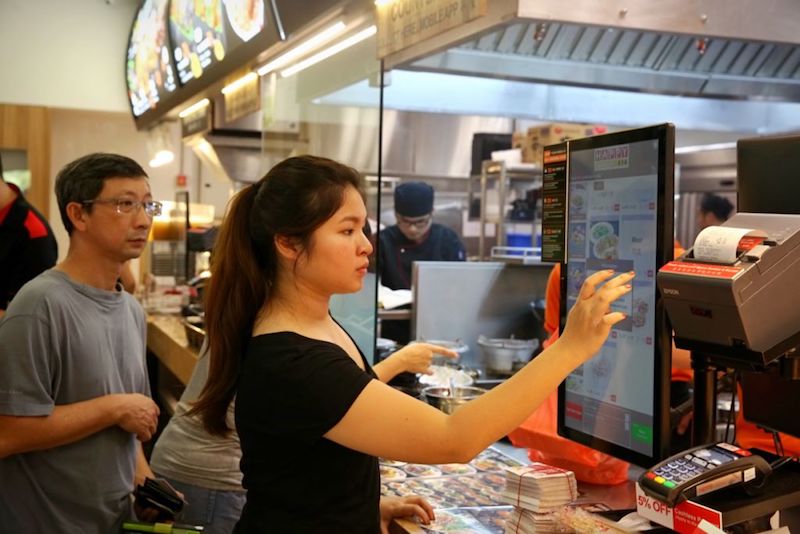 To boost productivity at Happy Hawkers in Tampines, customers place their orders on self-ordering machines. — TODAY pic
