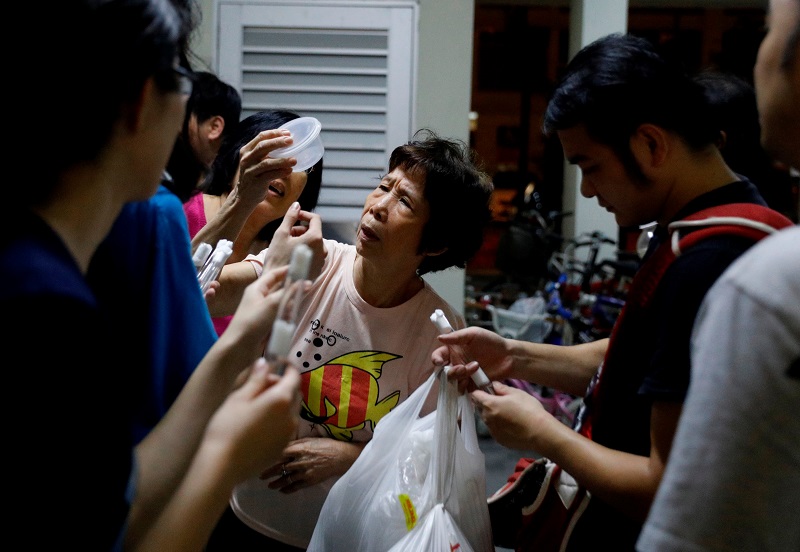 A curious resident looks at ants caught by a group of enthusiasts at a public housing estate in Singapore May 3, 2017. u00e2u20acu201d Reuters pic