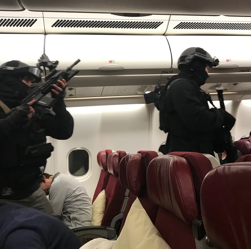 This handout photo by passenger Andrew Leoncelli shows heavily-armed police walking through Malaysia Airlines Flight MH128 to arrest a man after the flight made an emergency landing in Melbourne. u00e2u20acu201d AFP pic