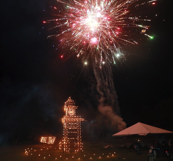 Fireworks light up the skies over a ‘panjut’ depicting a clock tower.