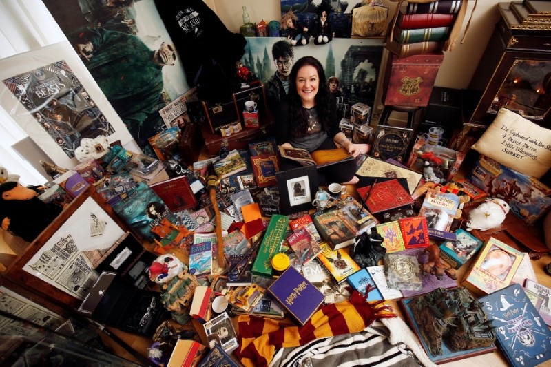Harry Potter fan Victoria Maclean poses amongst her collection of merchandise at her home in Neath February 9, 2017. — Reuters pic