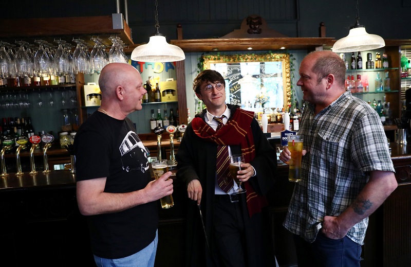 Professional Harry Potter impersonator Luke Williams (centre) enjoys a drink at a pub in London May 1, 2017. — Reuters pic