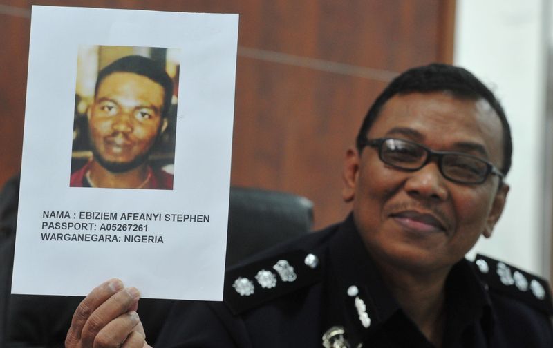 Brickfields district police chief ACP Ruslan Khalid holding the suspectu00e2u20acu2122s image of a Nigerian, Ebiziem Afeanyi Stephen whom police believe was involved in the case of a boy being tortured to death, during a press conference at Brickfields District Polic
