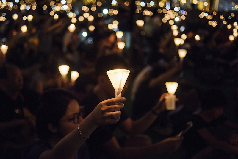 People raise their candles in Hong Kong's Victoria Park on June 4, 2017, during a vigil to mark the 28th anniversary of the June 4 Tiananmen crackdown in Beijing in 1989. u00e2u20acu201d AFP pic