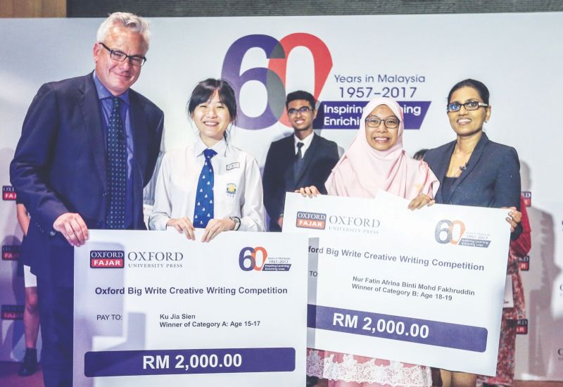 Mellor and Sharmini flank storywriting winners Ku and Nur Fatin. u00e2u20acu201d Picture by Firdaus Latif. u00e2u20acu201d file pic