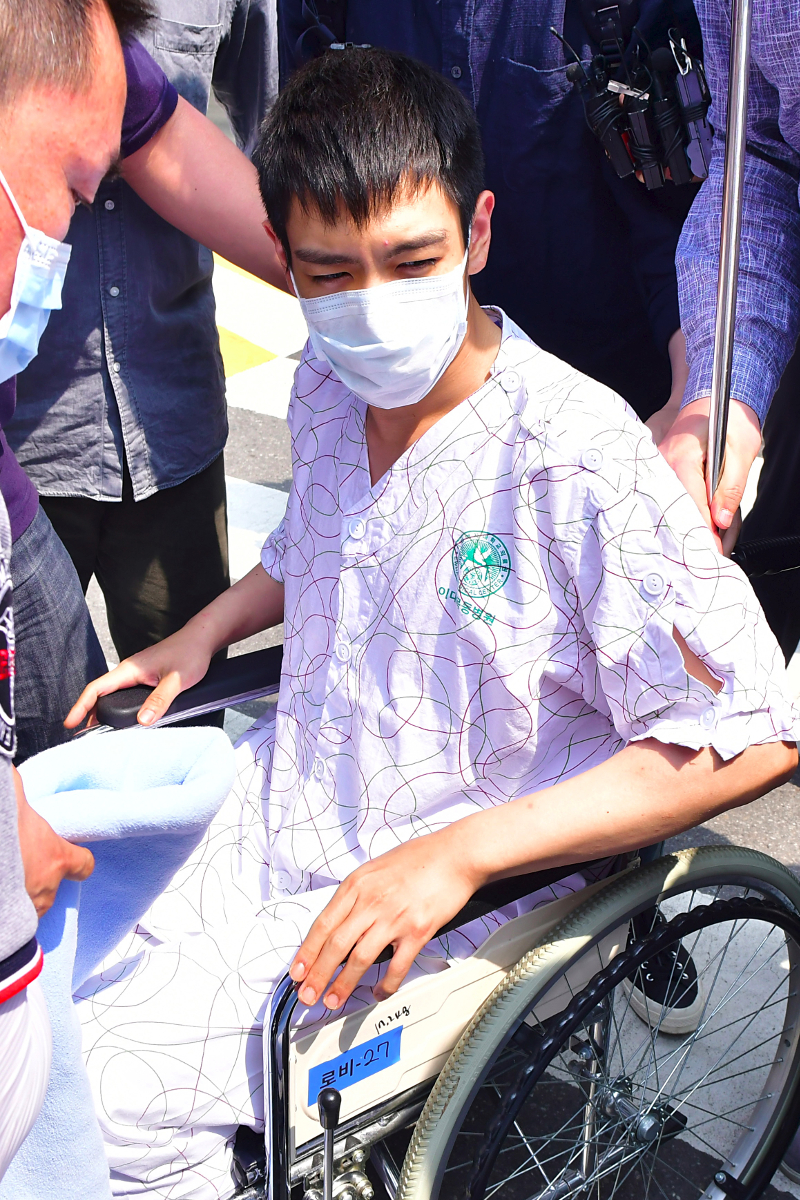 South Korean pop star TOP (on wheel-chair), rapper of K-pop boy band Big Bang, emerges from the intensive care unit of a hospital in Seoul on June 9, 2017. — AFP pic