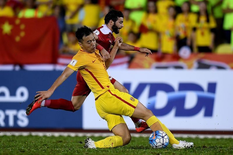 Feng Xiaoting of China (left) vies for the ball with Mahmoud Almawas of Syria in their Fifa World Cup 2018 Group A third round qualifying match at the Hang Jebat Stadium in Kampung Kerubong in Melaka on June 13, 2017. u00e2u20acu201d AFP pic
