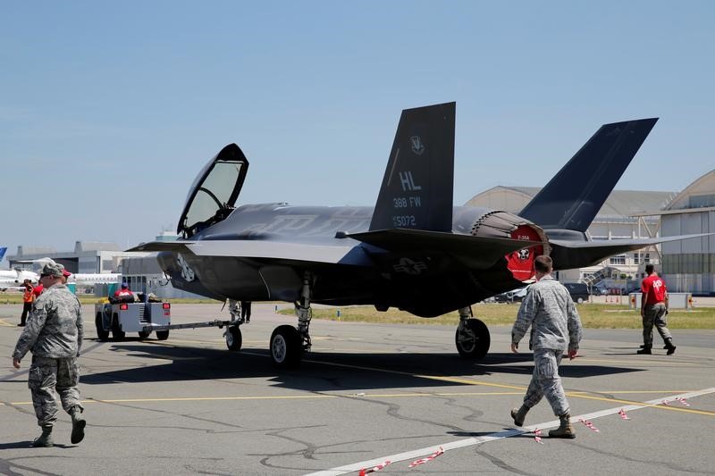 US airmen walk next to a Lockheed Martin F-35 Lightning II aircraft, as it is moved, on the eve of the 52nd Paris Air Show at Le Bourget Airport June 18, 2017. u00e2u20acu201d Reuters picn