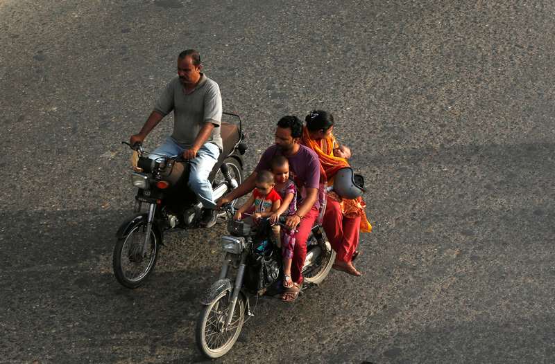 A family rides on a motorcycle along a road in Karachi June 13, 2017. u00e2u20acu201d Reuters pic