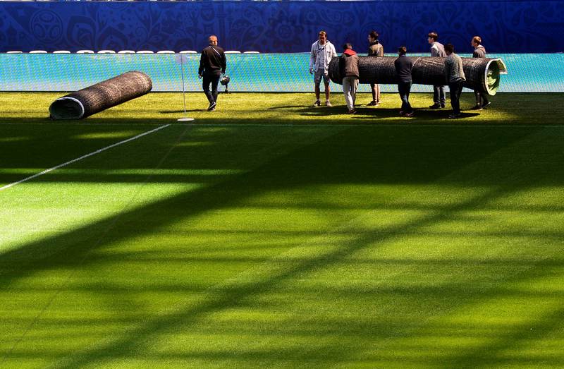 Workers carry a tarpaulin at Krestovsky Stadium in Saint-Petersburg June, 15, 2017. u00e2u20acu201d AFP pic