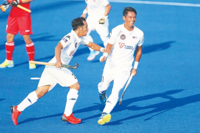 Tengku Ahmad Tajuddin Tengku Abdul Jalil (left) celebrates Razie Rahim's goal against South Korea.