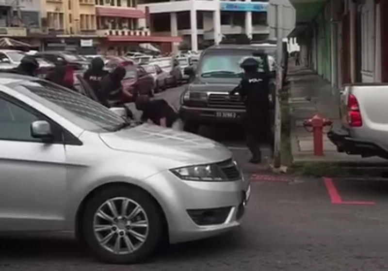 Video screenshot shows police arresting two persons suspected of terror links in Sandakan, Sabah at noon June 15, 2017.