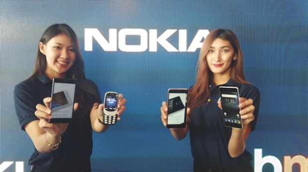 Models showing the new Nokia smartphones including the iconic Nokia 3310.