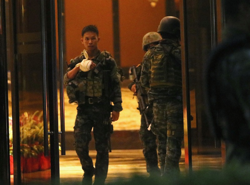 A injured policeman is seen at the entrance of a hotel after a shooting incident inside Resorts World Manila in Pasay City, Metro Manila, Philippines June 2, 2017. u00e2u20acu201d Reuters pic