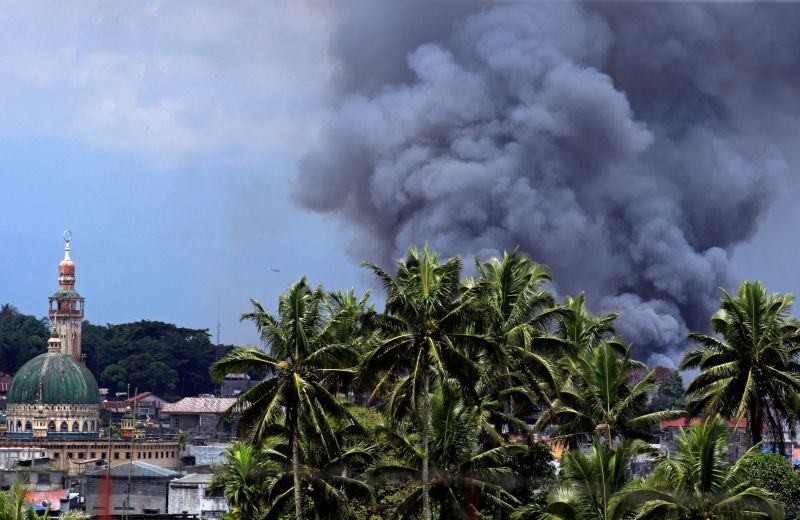 Black smoke comes from a burning building as government troops continue their assault against insurgents from the Maute group, who have taken over large parts of Marawi city, Philippines June 14, 2017. u00e2u20acu201d Reuters pic