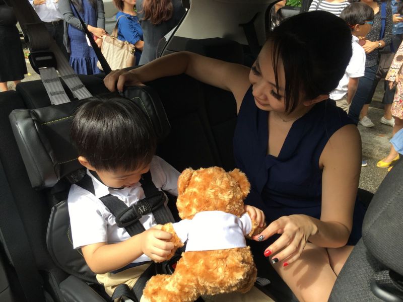Sandra Goh, 36, and her son, Vayeus Pang, 3, demonstrating a folding car seat that will be used in 100 UberX private-hire cars from tomorrow as part of a trial. u00e2u20acu201d TODAY pic
