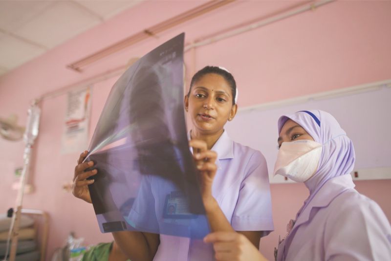 Nurse Lalitha Gopalan and Azreen Syazana check an X-ray film for symptoms of TB at a respiratory clinic. u00e2u20acu201d Picture by Azneal Ishak