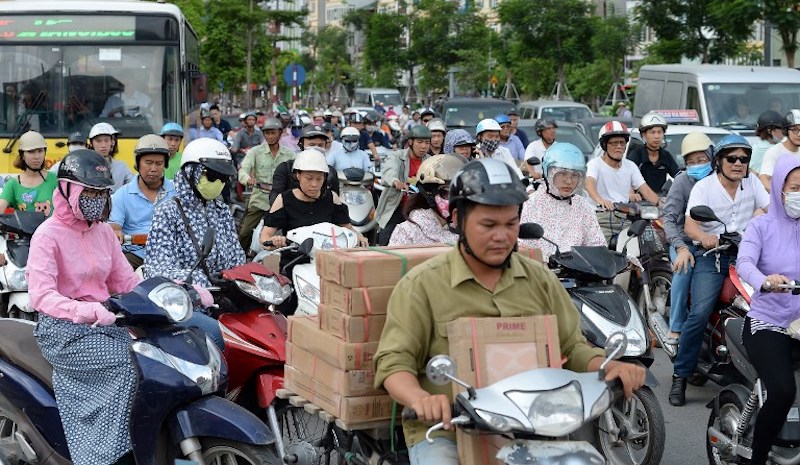 Motorcyclists cross an intersection in downtown Hanoi July 4, 2017. u00e2u20acu201d AFP pic