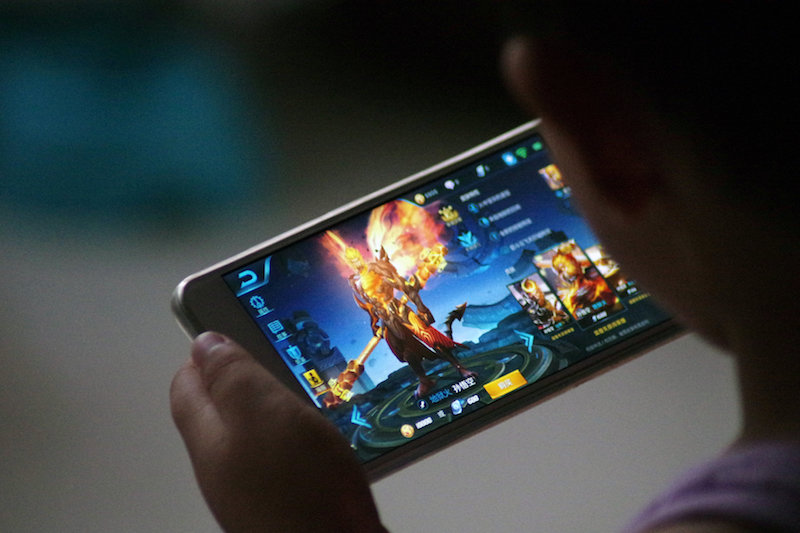 A child plays the game u00e2u20acu02dcKing of Gloryu00e2u20acu2122 by Tencent at home in Dezhou, Shandong province, China July 2, 2017. u00e2u20acu201d Reuters pic
