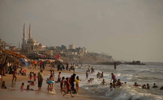 Palestinians swim in the Mediterranean Sea in Beit Lahiya town, in the northern Gaza Strip, July 6, 2017. 