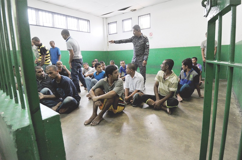An Immigration officer segregates the sickly detainees from the others before providing medical care. u00e2u20acu201d Picture by Mukhriz Hazim