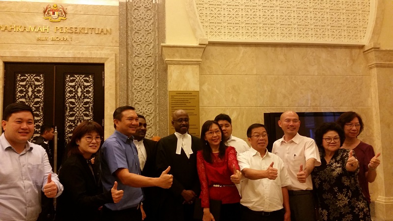 Seputeh MP Teresa Kok (sixth from right), fellow DAP leaders, supporters and her lawyers pose for a photo after the Federal Court ruling in Putrajaya July 11, 2017. u00e2u20acu201d Picture by Ida Lim