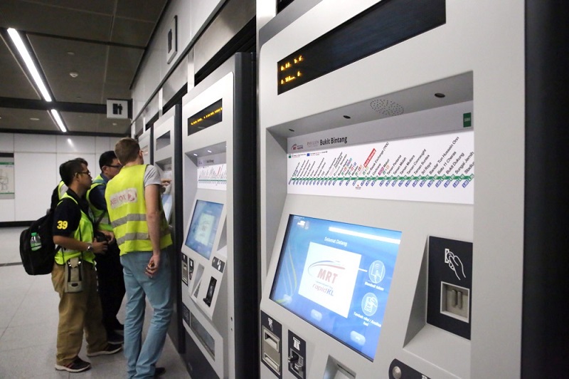 People examine the ticketing machines at the Bukit Bintang MRT station in Kuala Lumpur July 13, 2017. u00e2u20acu201d Picture by Choo Choy May