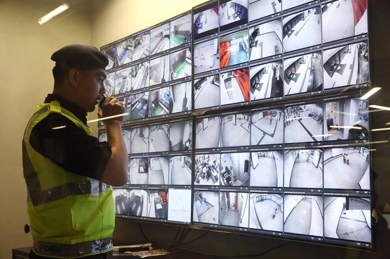 An auxilliary policeman looks at video footage from CCTV cameras at an MRT station along the Sungai Buloh-Kajang line. — Picture by Choo Choy May