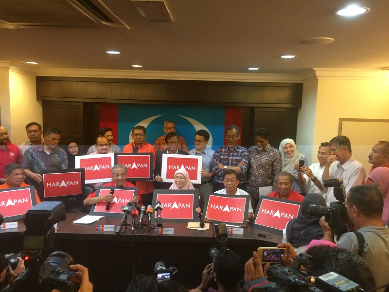 Pakatan Harapan leaders pose for a photo while holding up posters of their new logo during a press conference in Kuala Lumpur July 13, 2017. u00e2u20acu201d Picture by Kamles Kumar