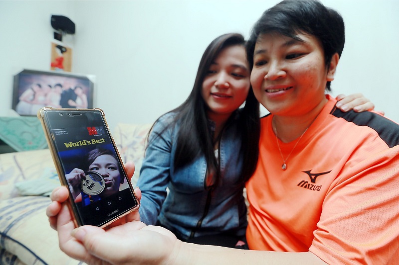 Cheong Jun Yeng (left) and Leow Lai Kuan reading about Cheong Jun Heong on the Malay Mail Afternoon E-paper. u00e2u20acu201d Picture byu00e2u20acu00a8Farhan Najib