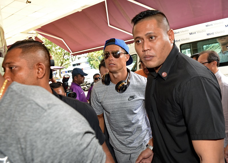 Portugal football player Cristiano Ronaldo (centre) arrives at Thomson Medical Hospital to visit the daughter of Singaporean billionaire Peter Lim who just gave birth in Singapore on July 21, 2017. u00e2u20acu201d AFP pic