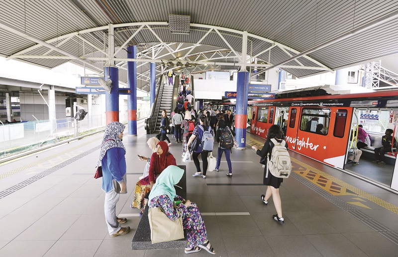 Commuters await their train ride at the station.