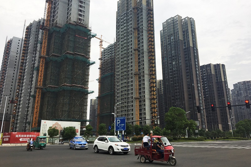 People drive past residential buildings under construction in Bengbu, Anhui province July 8, 2017. u00e2u20acu201d Reuters pic