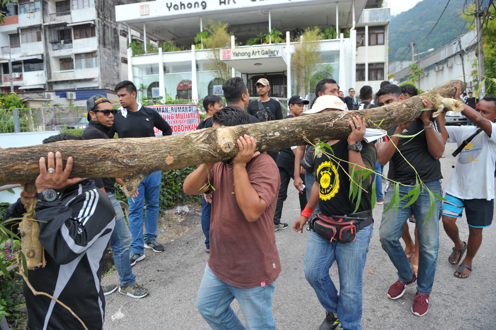 Protesters taking away a log which they used to block the entrance to their village in Kampung Mutiara July 31, 2017.