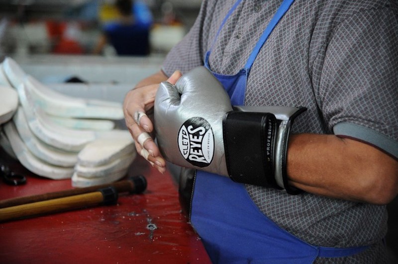 A worker shapes and tests boxing gloves at Reyes Industries in Mexico City on July 6, 2017. u00e2u20acu201d AFP pic