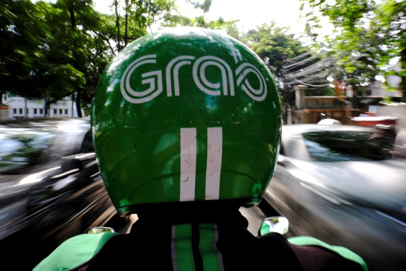 A Grab motor driver is seen in a street in Jakarta, Indonesia February 13, 2017. u00e2u20acu201d Reuters pic